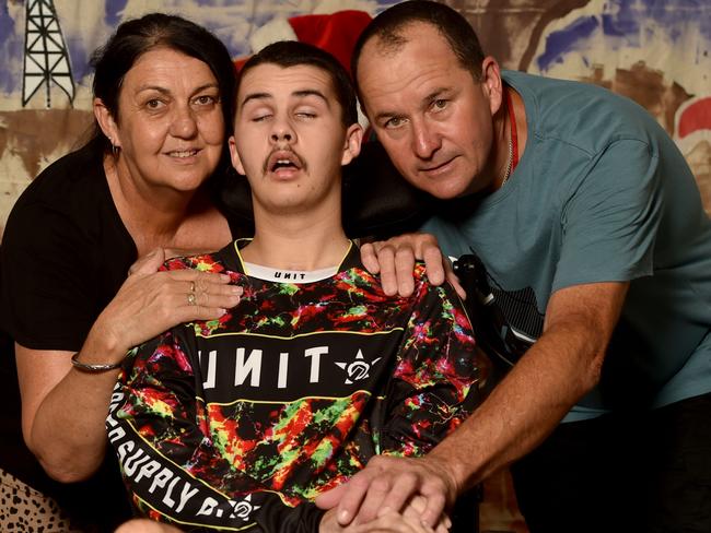 Trent Atto, with his mum Debbie Watson and dad Ray Atto at Rolad McDonald House, is recovering from a severe brain injury. Picture: Evan Morgan