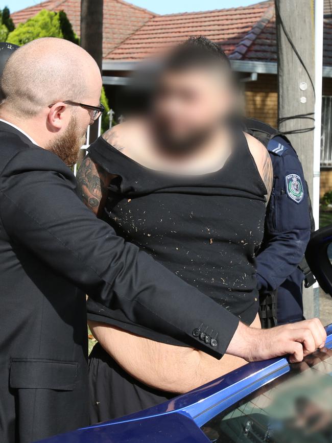 Alleged drug dealer Danny Watfa speaks with detectives before being placed inside an unmarked police vehicle bound for Bankstown Police Station. Picture: NSW Police Force