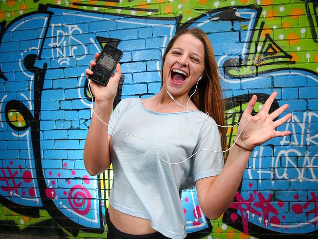 Apple last night announced a new music streaming set to take over current listening giants spotify and pandora. Monica Ireland listens to her music on her iPhone. Picture: Ian Currie