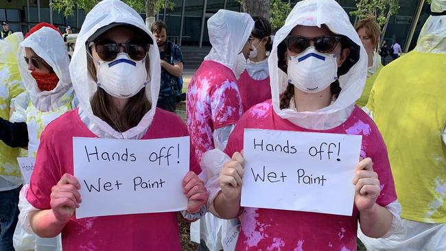 The demonstrators hope the wet paint might help them avoid being touched by police. Picture: Brianna Travers