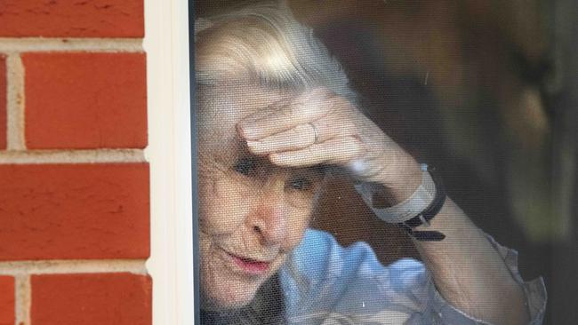 An aged-care resident looks out the window of the Coppin Centre in Melbourne’s Footscray on Monday. Picture: Tony Gough