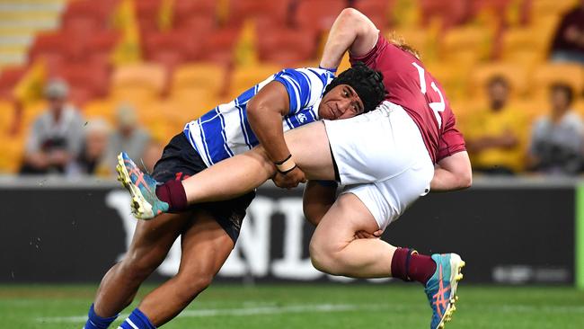 Eyzaiah Ulia of Nudgee College tackles Wian Joubert of Brisbane State High. Picture: AAP