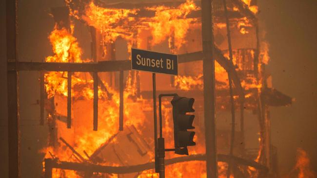 Flames from the Palisades Fire burn a building on Sunset Boulevard on January 8. Picture: Apu Gomes/Getty Images/AFP