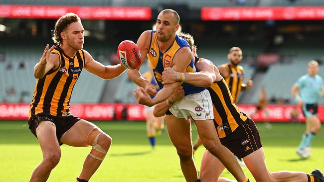 Dom Sheed feeds out a handball under pressure.