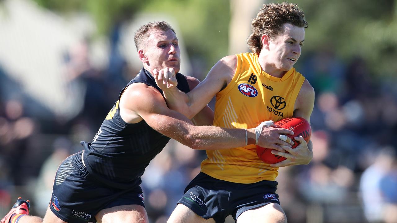 Rory Laird tackles Zac Taylor in the Crows’ internal trial. Picture: Sarah Reed/AFC