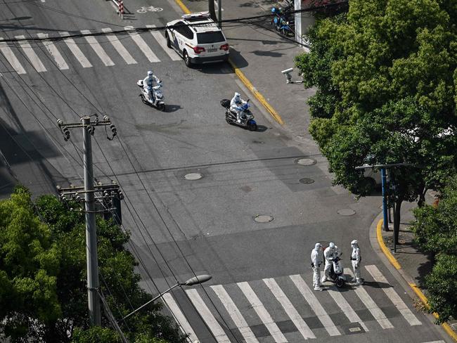 Policemen at a check point on a street during a Covid-19 lockdown in the Jing'an district in Shanghai on May 2, 2022 Picture: Hector Retamal/AFP