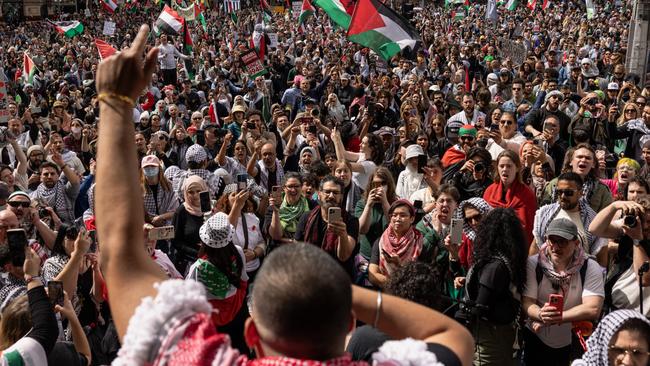 Pro-Palestine activists gather at Flinders Street Station in Melbourne during an organised protest in commemoration of the anniversary of the war in Gaza.