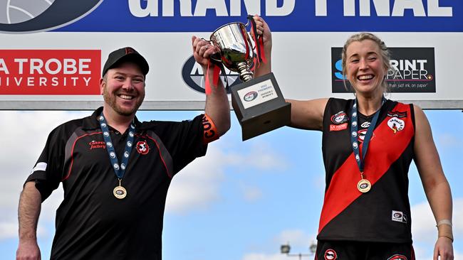 Eltham coach David Cardamone and captain Jacki White lift the cup. Picture: Andy Brownbill