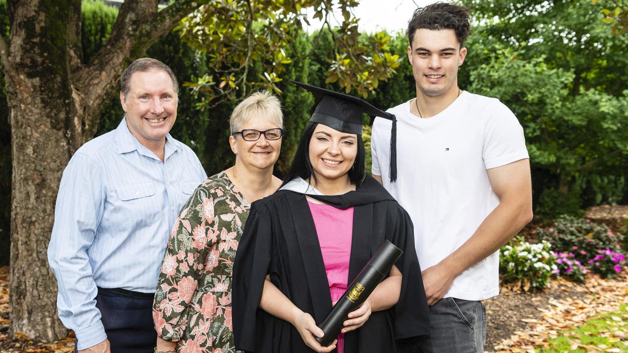 Bachelor of Business graduate Kimberley Wippell is congratulated by (from left) Brian and Kellie Wippell and Sam Taylor at the UniSQ graduation ceremony at Empire Theatres, Tuesday, December 13, 2022. Picture: Kevin Farmer