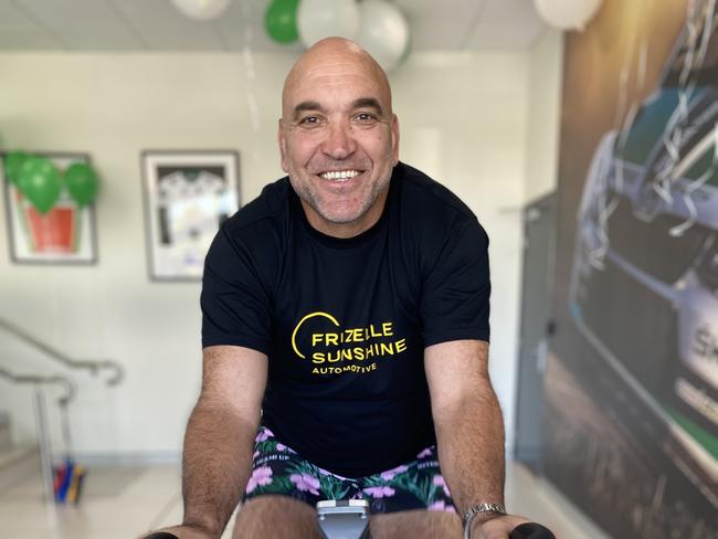 Rugby legend Gorden  Tallis at Frizelle Sunshine Automotive in Southport riding a spin bike to raise money for the Children's Starlight Foundation Tour De Kids. Photo: Supplied