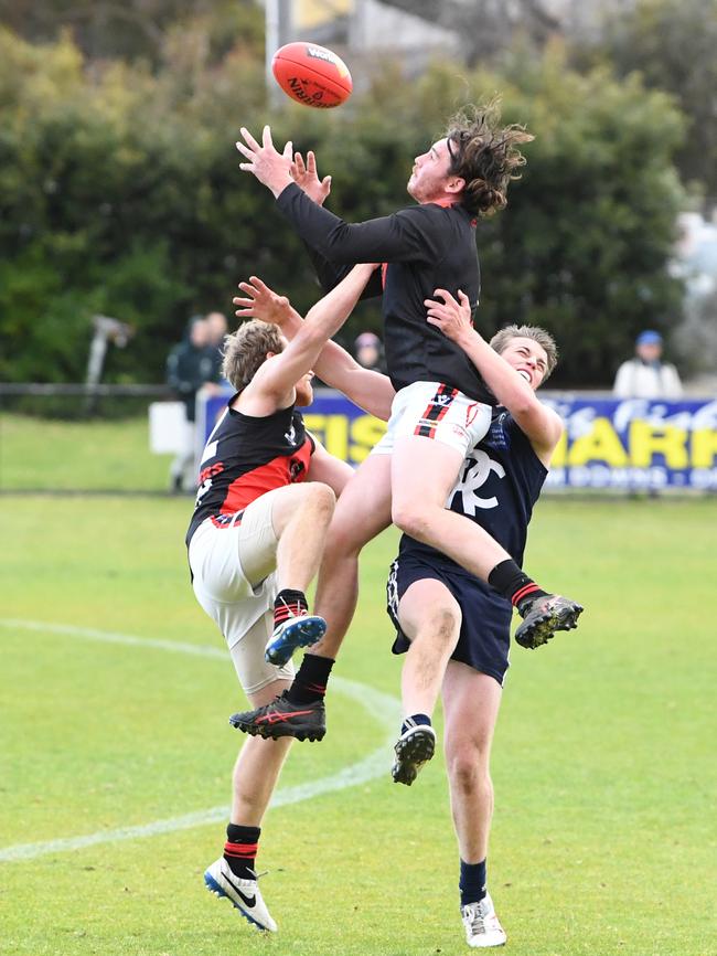 Frankston's Corey Buchan springs for a mark against Rosebud.