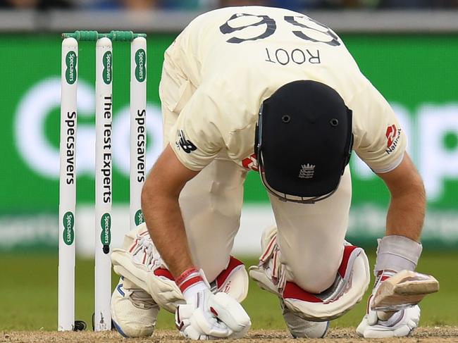 England's captain Joe Root reacts after being hit by a ball bowled by Australia's Mitchell Starc during play on the third day of the fourth Ashes cricket Test match between England and Australia at Old Trafford in Manchester, north-west England on September 6, 2019. (Photo by Oli SCARFF / AFP) / RESTRICTED TO EDITORIAL USE. NO ASSOCIATION WITH DIRECT COMPETITOR OF SPONSOR, PARTNER, OR SUPPLIER OF THE ECB