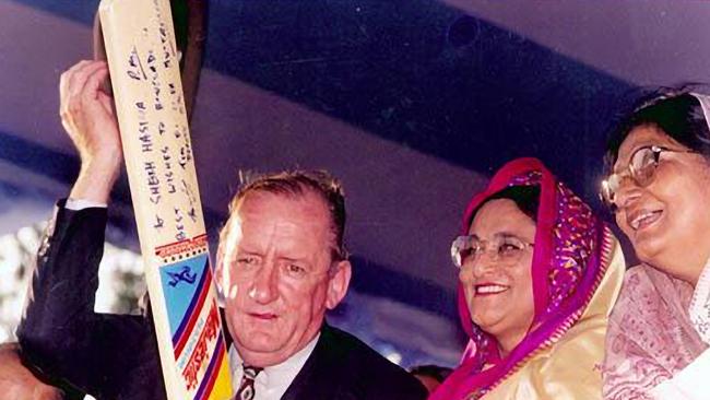 Fischer wielding a signed bat that he presented to the Bangladeshi Prime Minister during a visit to Bangladesh in April 1997.