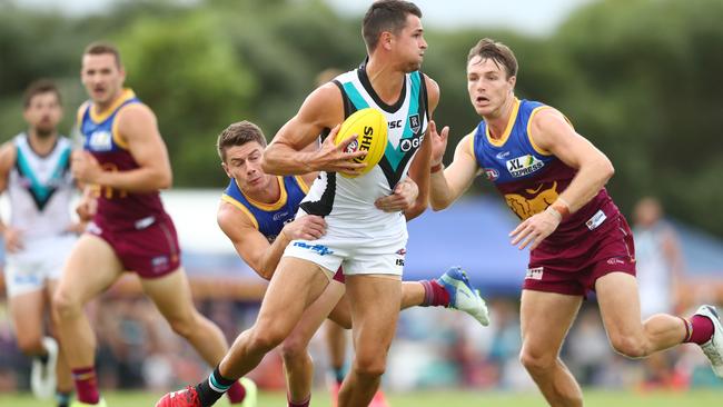 GOING NOWHERE: Port Adelaide’s Ryan Burton is tackled by Brisbane’s Dayne Zorko. Picture: CHRIS HYDE (AFL Photos/Getty Images).