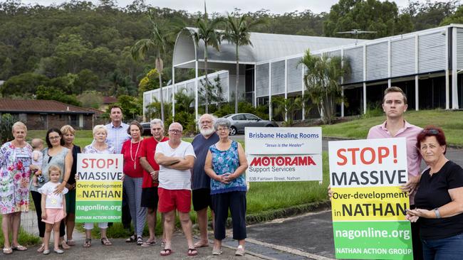 Nathan Action Group spokesman Blake Buchanan and Annamarie Newton (on right) and fellow locals pose for a photograph in Fairlawn Street. (AAP Image/Renae Droop)