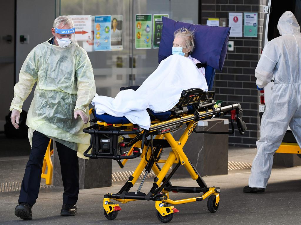 Medical workers evacuate a resident from the Epping Gardens aged care facility on July 30. Picture: William West/AFP