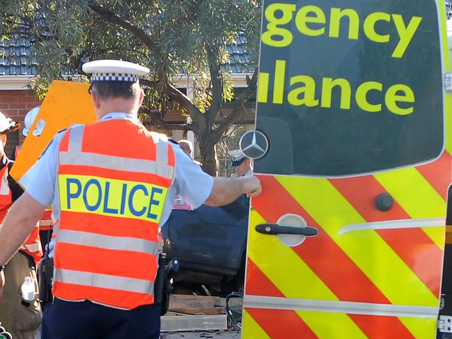 SA road accident scene - Holden Commodore utility collided with truck at Mooringe Avenue in North Plympton - man cut from his vehicle after colliding with truck is put into ambulance.