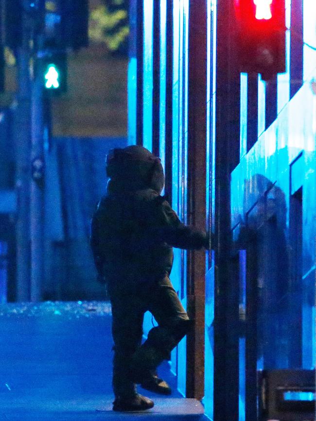 This officer had to clear the cafe for explosives. Picture: Daniel Munoz