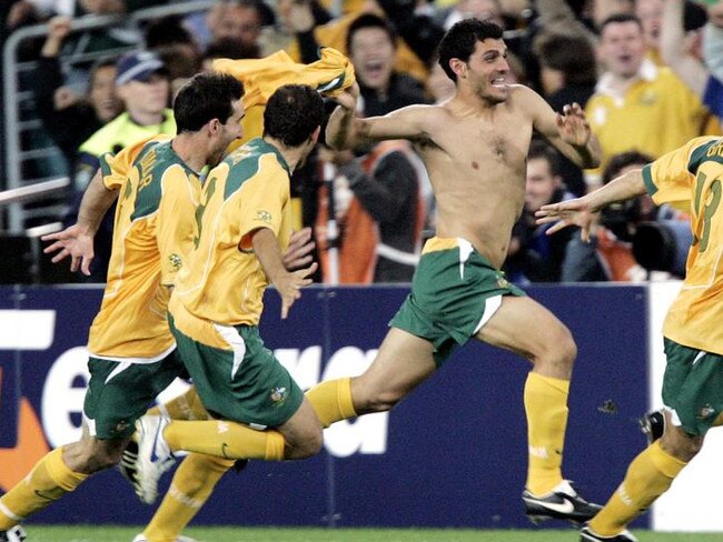 WIRE: Socceroos (L-R) Tony Vidmar, Scott Chipperfield, John Aloisi and Vincent Grella celebrate after defeating Uruguay on penalties during their second leg World Cup qualifier, Australia v Uruguay at Sydney's Telstra Stadium, 16/11/2005. Australia booked a World Cup 2006 finals berth for the first time in 31 years.