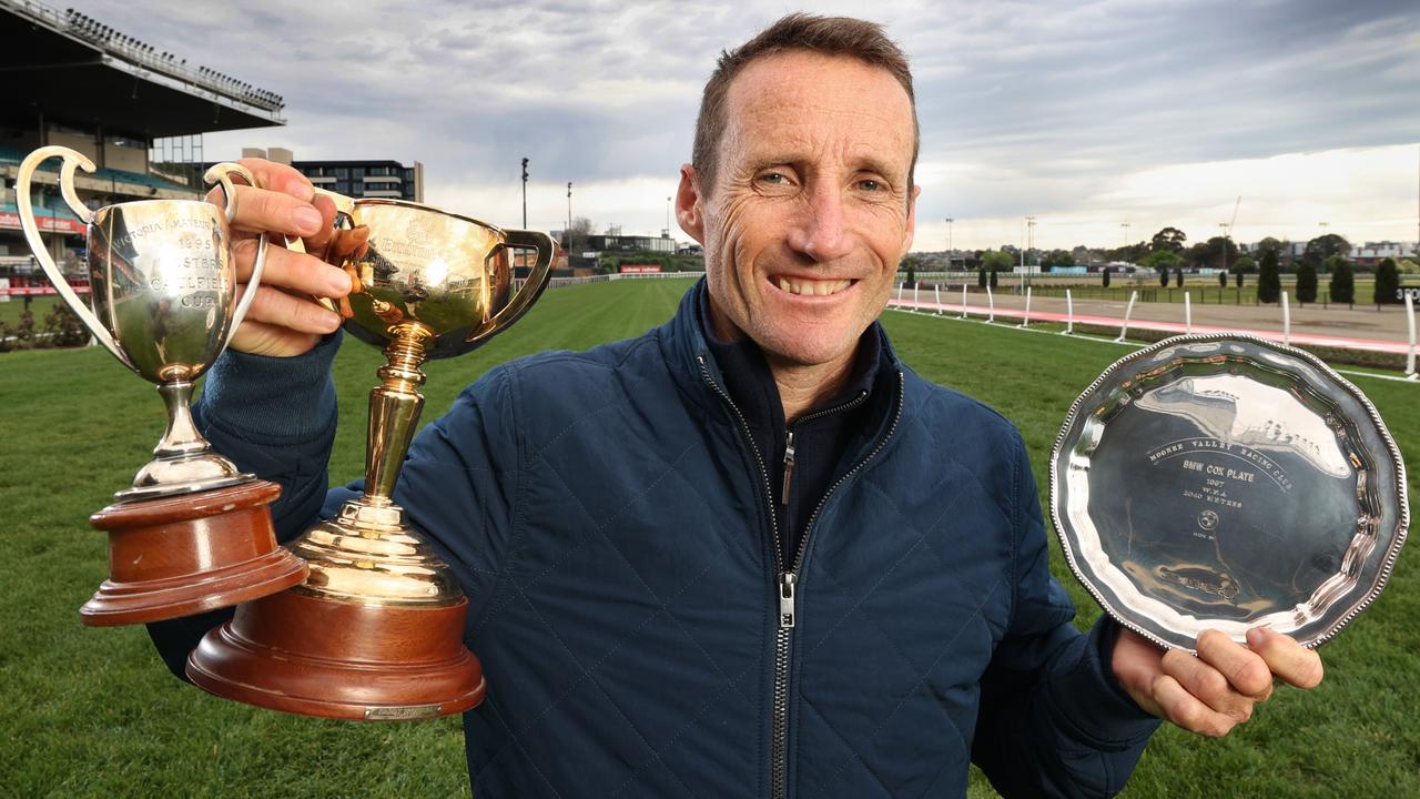 Damien Oliver at Moonee Valley on Tuesday with some of his prized silverware. Picture: David Caird