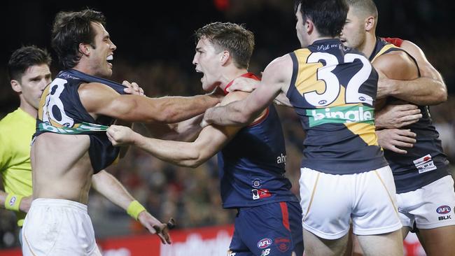 Melbourne players remonstrate with Alex Rance. Picture: Michael Klein