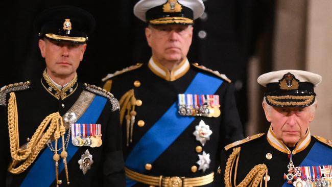 King Charles III, Prince Andrew, Duke of York, and Prince Edward, Earl of Wessex arrive to mount a vigil around the coffin of Queen Elizabeth II. (Photo by Daniel LEAL / POOL / AFP)