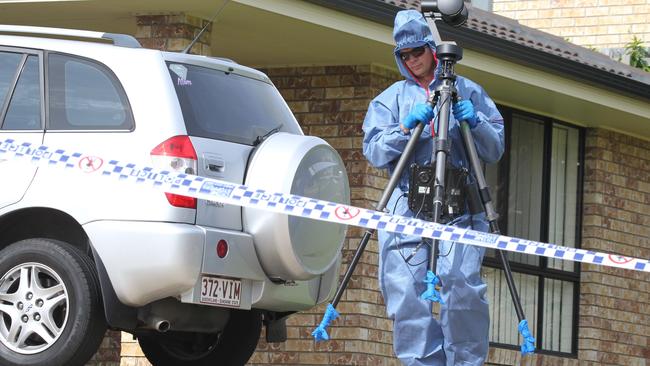 Police comb the area in front of the Upper Coomera house where two bodies were found. Picture: Mike Batterham