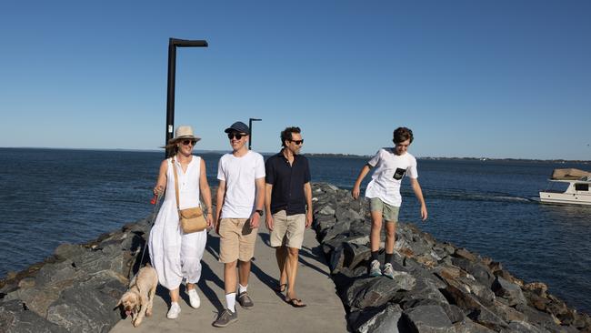 Fun in the sun: Sarah Tebbutt and Sergio Zaccaria take a stroll on the Manly rock wall with their boys, Oliver and Sebastian, and dog, Buddy. Picture: David Kelly