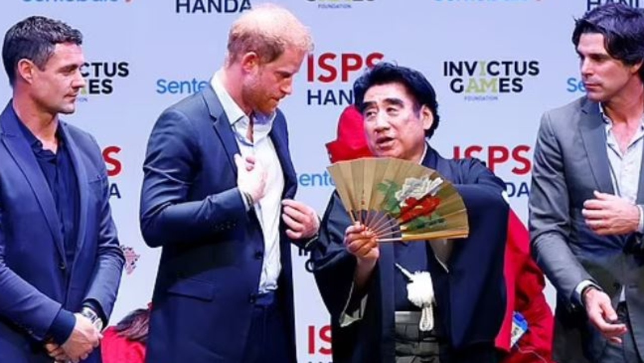 Prince Harry talks with Haruhisa Handa (centre) next to ex-New Zealand rugby player Dan Carter (left) and Argentine polo player Nacho Figueras (right) in Tokyo. Picture: Reuters