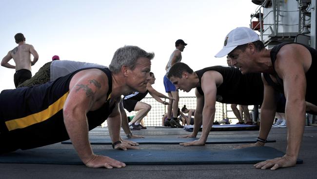 Then Lieutenant-Commander Eric Young, left, in training exercises on the flight deck of HMAS Anzac in 2001