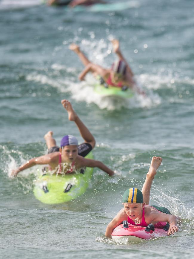 Competitors in action during the All Ages Board Relay during the Surf Life Saving Central Coast junior branch carnival at Copacabana Beach on Sunday. Picture: Troy Snook