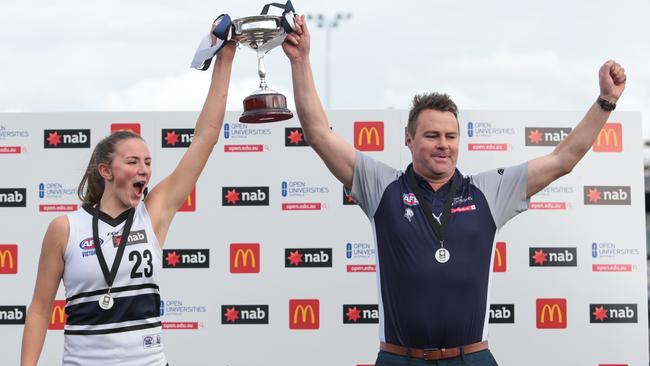 Northern Knights captain Gabrielle Newton and coach Marcus Abney-Hastings lift the cup.