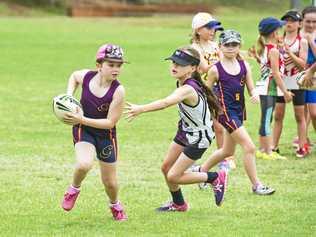 HARD AT WORK: Putting their skills on show during a Karley Banks touch football clinic are young players Chloe Archinal (left) and Ciara Thompson. Close to 200 Toowoomba players will attend the clinic at Kearneys Spring Sports Complex this week. Picture: Nev Madsen