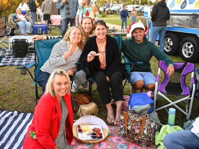 Katie Bland, Danielle Martineau, Josie Thornborrow, Trish Callis and Michael Callis getting festive at the Phillip Island Christmas Carols by the Bay at the Cowes Foreshore on Tuesday, December 10, 2024. Picture: Jack Colantuono