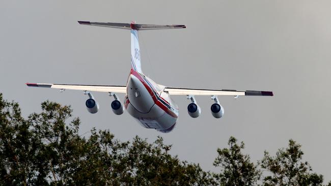 A fire bombing aircraft over Salt Ash on Friday morning. Picture: AAP