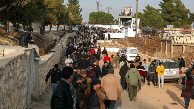 People gather at the Sednaya prison in Damascus looking for loved ones. Picture: AFP.