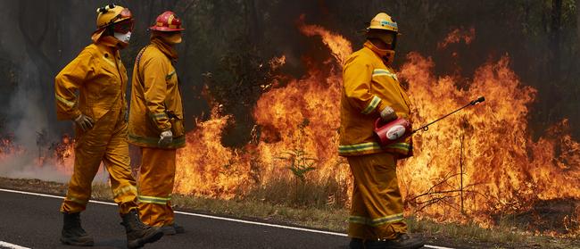 CFA Members work on controlled back-burns along Putty Road on Saturday. Picture: Getty