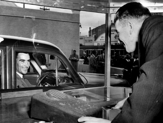 Teller is RD Long serves a customer at the drive thru bank in 1954. The concept didn’t catch on. Picture: The Argus.