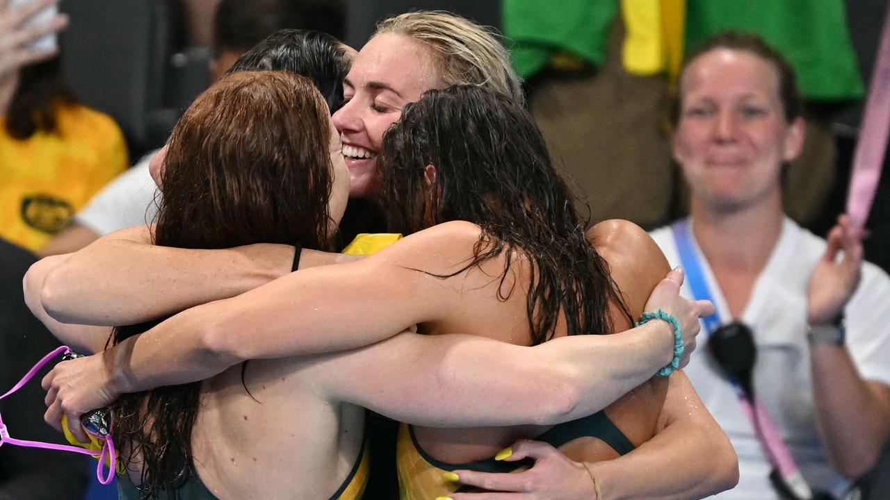 Team Australia's Mollie O'Callaghan, Lani Pallister, Brianna Throssell and Ariarne Titmus embrace after their gold medal win. Picture: Jonathan Nackstrand/AFP)