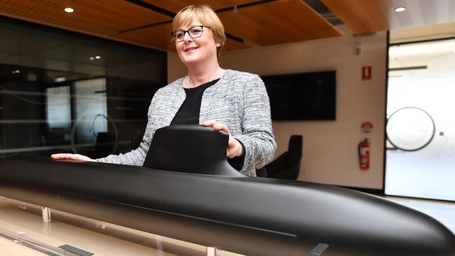 Former federal defence minister Linda Reynolds poses for a photo next to a model of the Barracuda-class submarine during a visit to Naval Group in Adelaide.