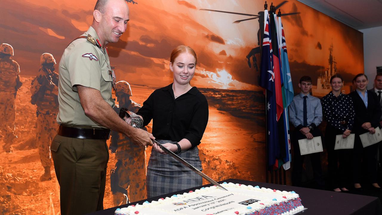 In an ADF tradition, Brigadier Kahlil Fegan cuts the cake with the youngest recruit, Jade Abrahams as the ADF formally welcomed 15 of its newest officer cadets at an appointment ceremony in Townsville. Picture: Matt Taylor