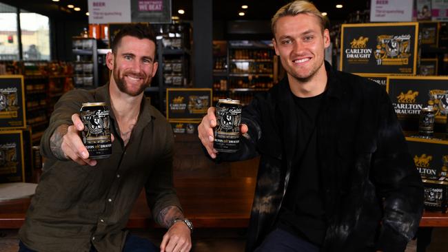 MELBOURNE, AUSTRALIA - OCTOBER 06: Jeremy Howe and Darcy Moore pose with the premiership cans during the 2023 Collingwood Magpies Premiership Cans Launch at Dan Murphy's Richmond on October 06, 2023 in Melbourne, Australia. (Photo by Josh Chadwick/Getty Images for TLA)