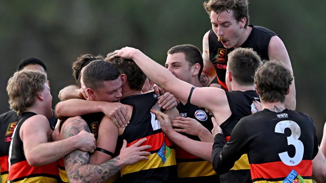 Teammates swamp Cachia to celebrate his achievement. Picture: Andy Brownbill