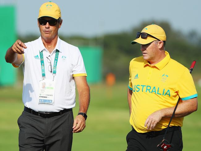 Australia team captain Ian Baker Finch waits on a green with Marcus Fraser.