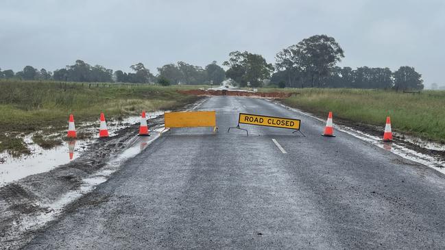 A sand levee bank was put in place on Tinamba-Seaton Rd where it was closed off. Picture: Jack Colantuono