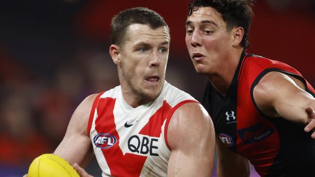 MELBOURNE, AUSTRALIA - JULY 29: Luke Parker of the Swans runs with the ball under pressure from Jye Caldwell of the Bombers during the round 20 AFL match between Essendon Bombers and Sydney Swans at Marvel Stadium, on July 29, 2023, in Melbourne, Australia. (Photo by Daniel Pockett/Getty Images)