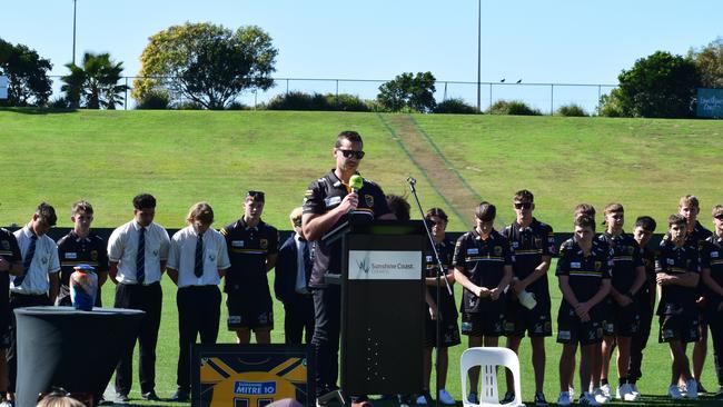 Sunshine Coast Falcons under-16s coach Tim Baldwin giving a speech as Benjamin Hunter's teammates stand side-by-side.