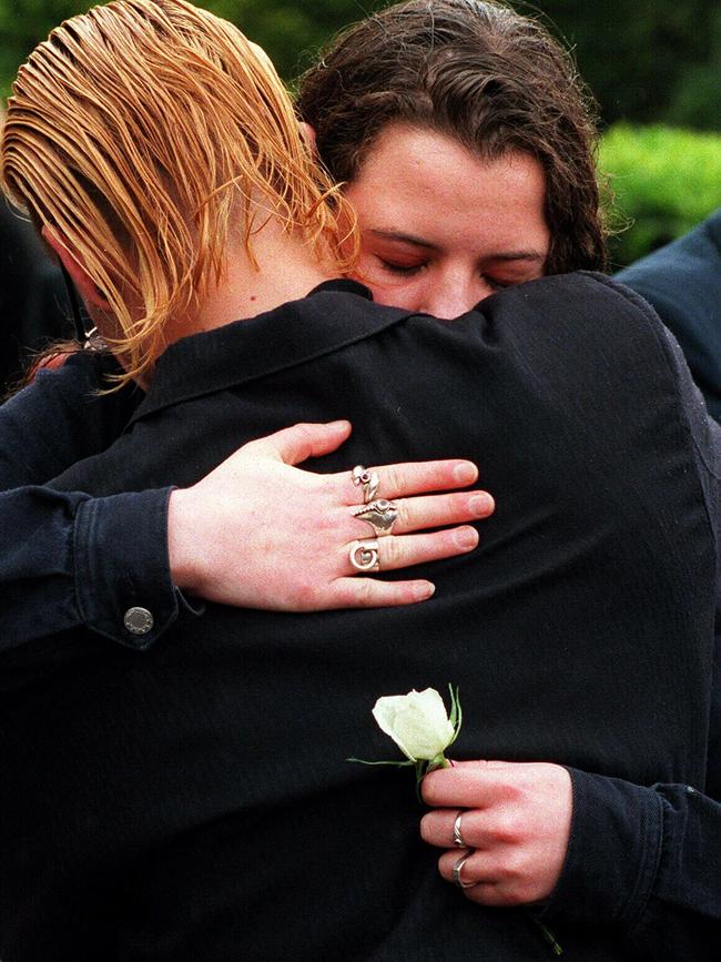 Grieving friends of Anna Wood at her funeral.