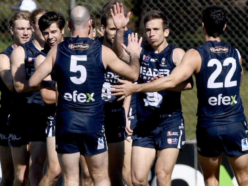 ADELAIDE, AUSTRALIA - AUGUST 29, 2020: Action from the South Adelaide/Central District SANFL game in Noarlunga - South Adelaide team mates congratulate Joel Cross on a goal. Picture: Naomi Jellicoe