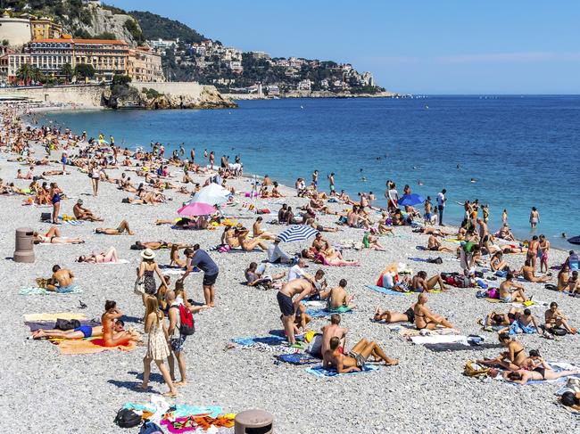 NICE, FRANCE - JUNE 22, 2016: Tourists enjoy sunny summer day at the municipal beach near Promenade des Anglais in City of Nice, Cote D'azur, French Riviera, Mediterranean sea, France  Picture: istock